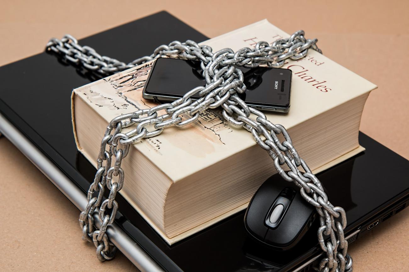 Devices locked with a chain, representing a secure and protected digital environment.