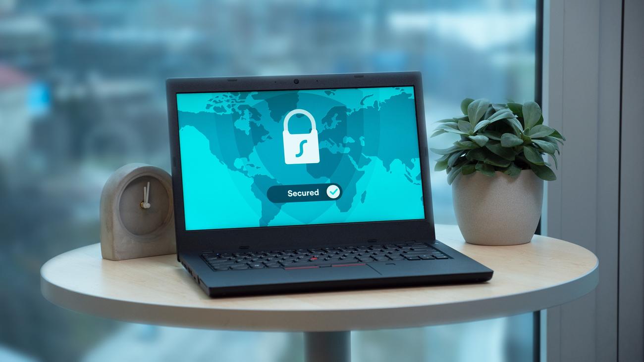 Laptop displaying a security lock icon on a table, representing digital protection and system security.
