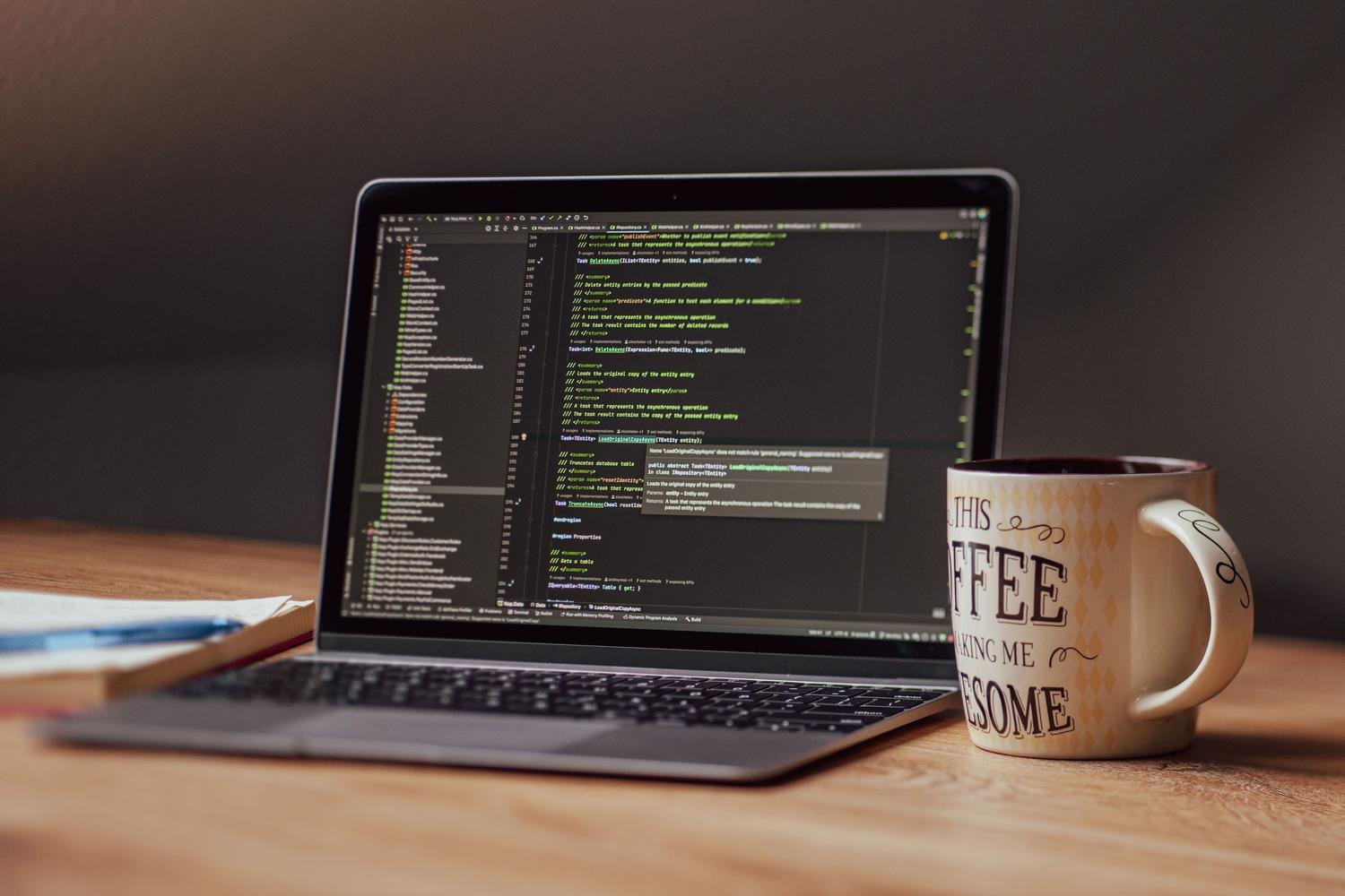 Persona trabajando com un ordenador portátil en um entorno de oficina moderno, simbolizando o uso de ferramentas de software profissionais.