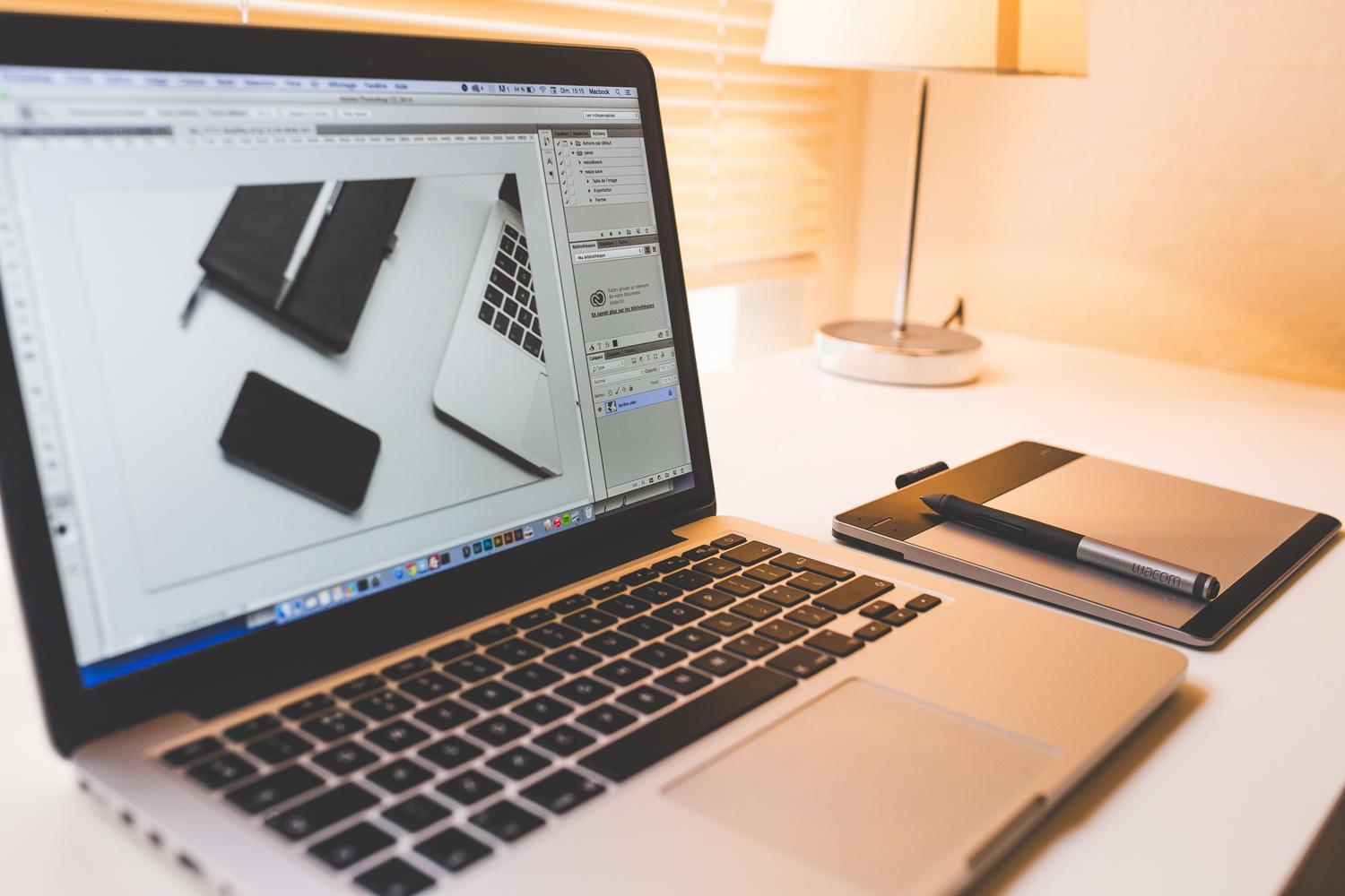 Modern digital workspace with a laptop and graphics tablet, representing professional video optimization.