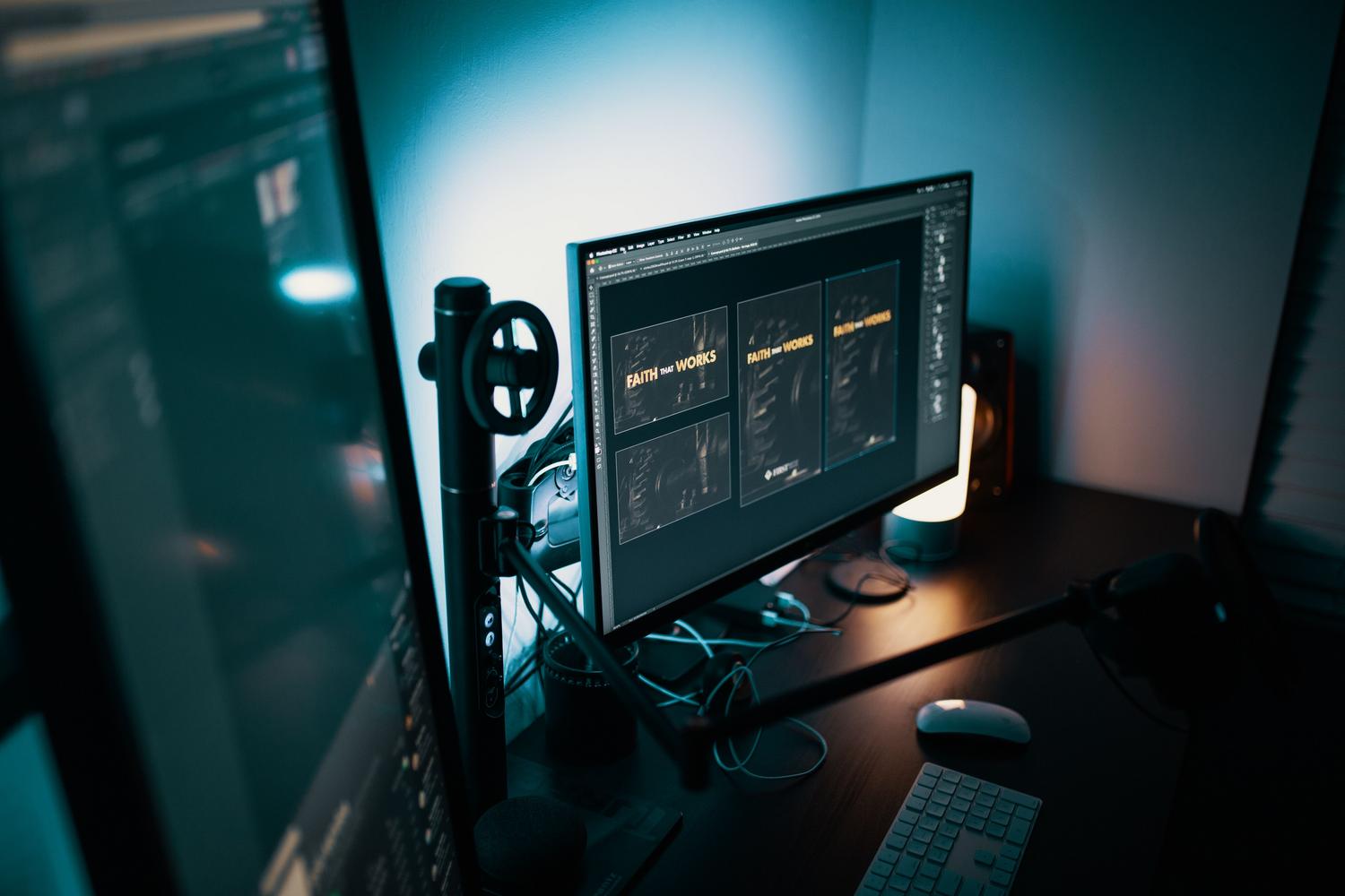 Espaço de trabalho de design profissional com monitores em ambiente tenuemente iluminado, ideal para ilustrar o uso profissional onde o DCR não é recomendável.