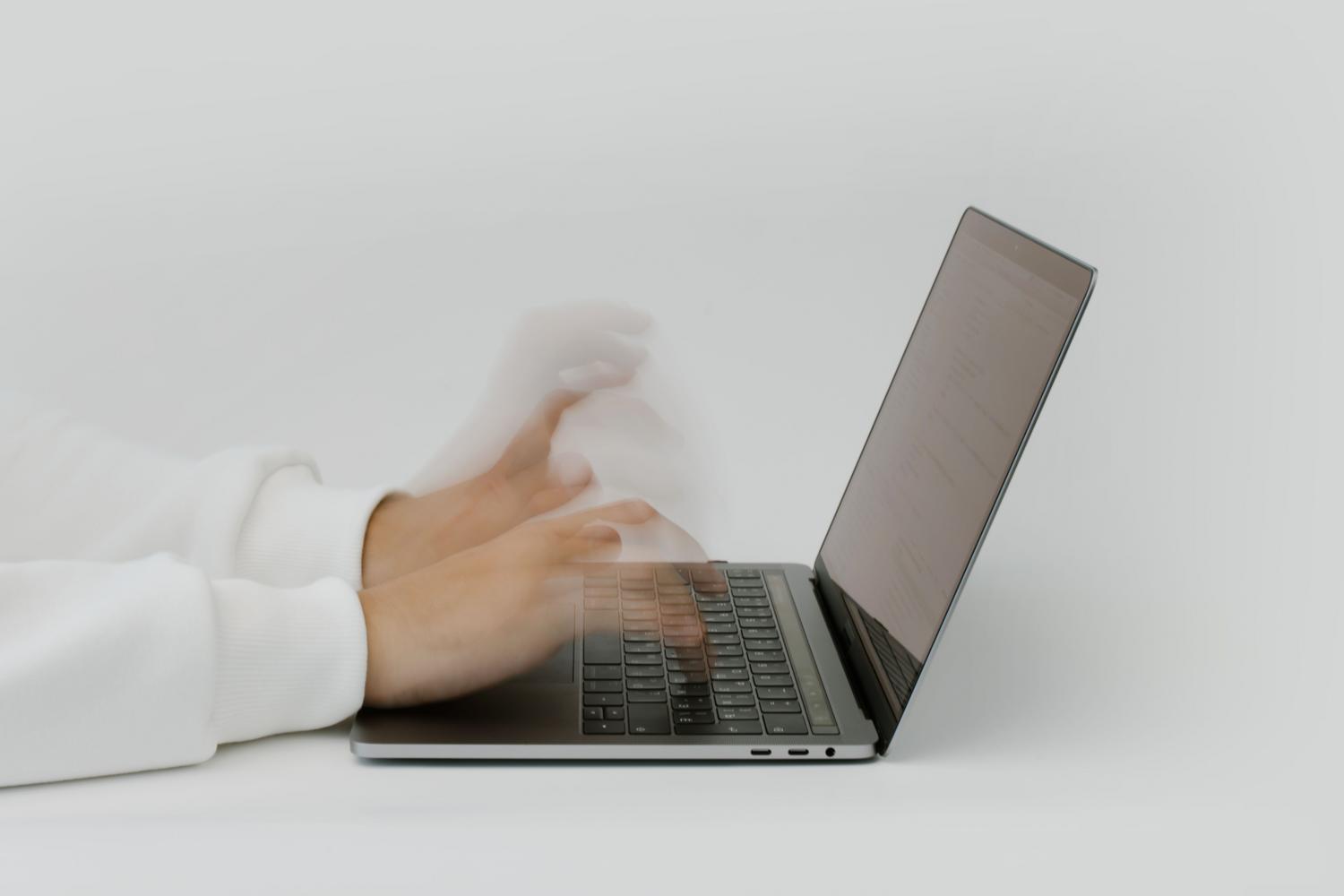 Primer plano de manos escribiendo rápido en un teclado, ilustrando la velocidad de carga y el alto rendimiento técnico.